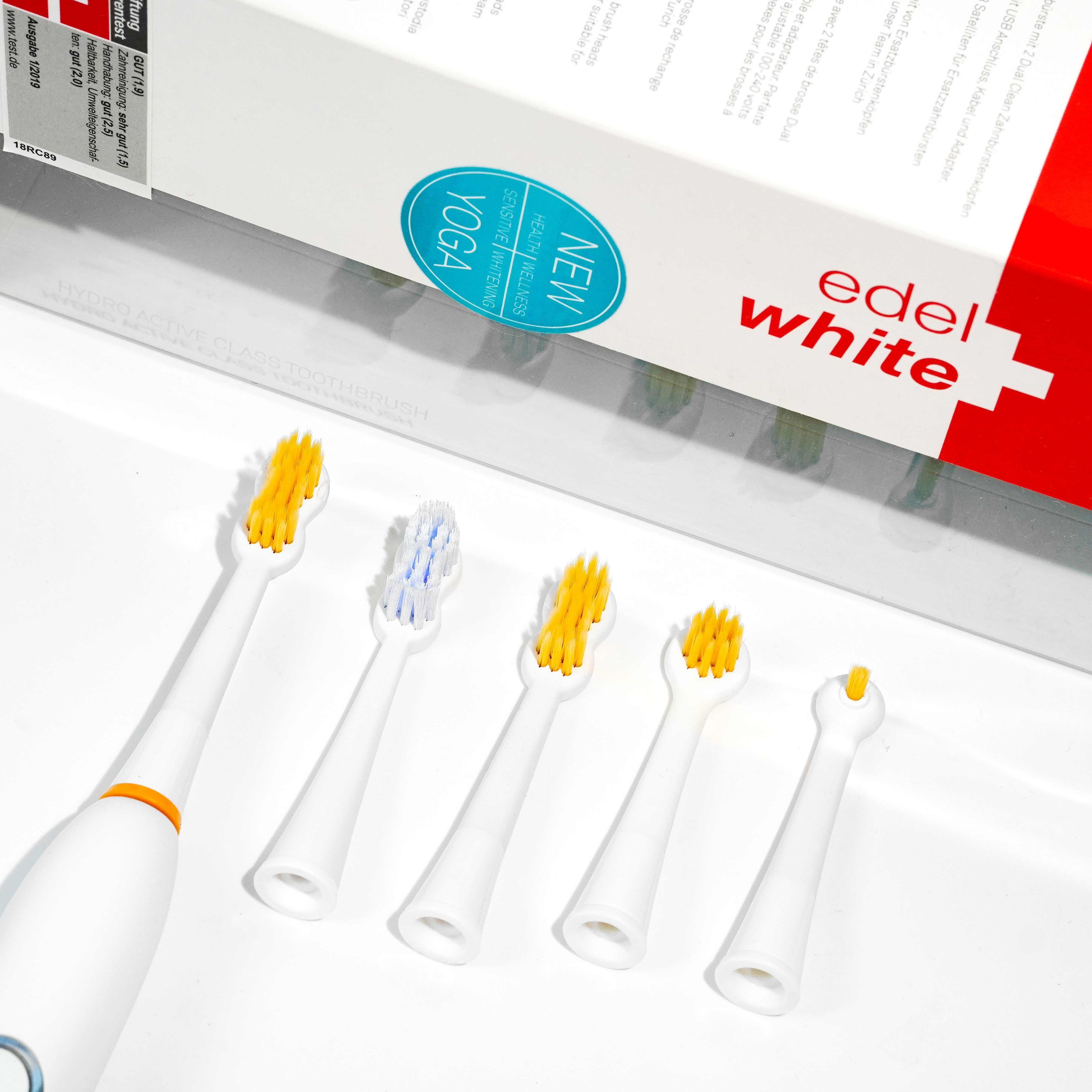 edel white hydrodynamic sonic toothbrush with UltraSoft brush heads