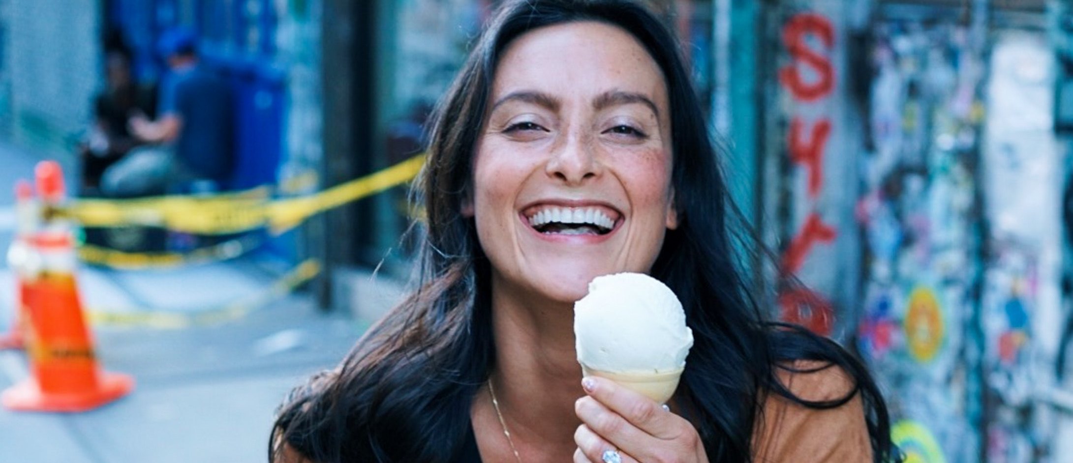 Young brunette woman smiling with ice cream